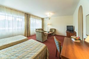 a hotel room with a bed and a table and a tv at Posadskiy Hotel in Sergiyev Posad