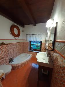 a bathroom with a tub and a toilet and a sink at Zielona Mila Dom Wakacyjny in Cekcyn