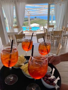 a table with three wine glasses and a tray of food at Casamediterranea in Sperlonga