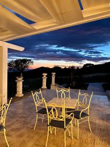 a table and chairs on a patio with a sunset at Casamediterranea in Sperlonga
