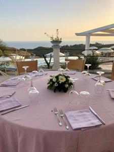 a table with a purple table cloth and utensils at Casamediterranea in Sperlonga