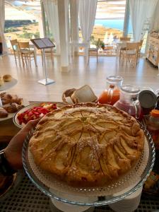 a pie sitting on a table with a plate of food at Casamediterranea in Sperlonga