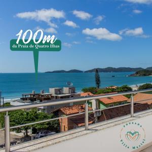 a view of the ocean from the balcony of a resort at Pousada Villa Maciel in Bombinhas