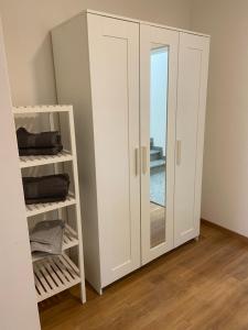 a white wardrobe with a glass door in a room at Appartments Siegenburg in Siegenburg