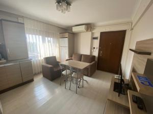 a small living room with a table and chairs at My Rezidans Hotel in Manisa