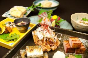 a bunch of different types of food on a table at Kadoya Hotel in Tokyo