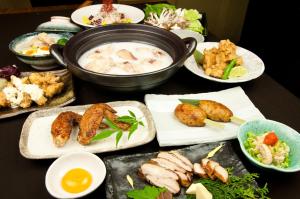 a table with plates of food and a bowl of soup at Kadoya Hotel in Tokyo