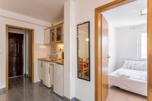 una stanza con una cucina, un letto e uno specchio di 5 min from beach and center of Bol a Bol