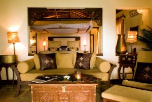 a living room with a couch and a bed at The Palms Zanzibar in Bwejuu