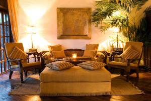 a living room with a couch and chairs and a table at The Palms Zanzibar in Bwejuu