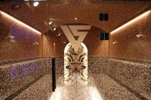 a bathroom with a toilet with the letter y on it at VERTEX SPA hotel in Estosadok