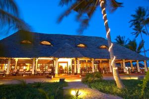 a building with a palm tree in front of it at The Palms Zanzibar in Bwejuu