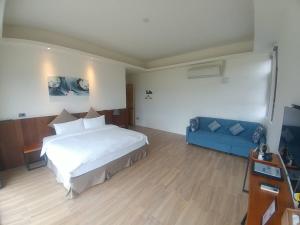 Rúm í herbergi á Yulaikung B&B