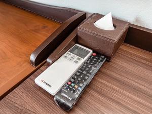 a remote control sitting on top of a wooden table at Piyada Residence Pattaya in Pattaya South