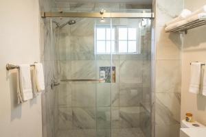 a shower with a glass door in a bathroom at Great Stay in San Jose in San Jose +36 photos