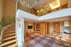a large room with a large staircase leading up to it at Dorsett Shanghai in Shanghai