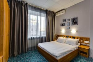 a hotel room with a bed and a window at Marins Park Hotel Rostov in Rostov on Don