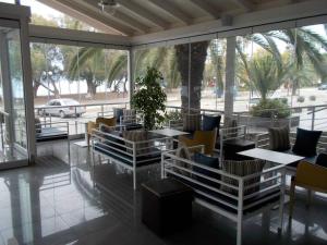 a restaurant with tables and chairs on a patio at Tokalis Boutique Hotel & Spa in Nea Anchialos