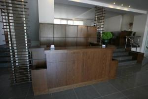 a lobby with a desk and stairs in a building at Tokalis Boutique Hotel & Spa in Nea Anchialos