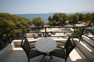 a table and two chairs on a balcony with a view at Tokalis Boutique Hotel & Spa in Nea Anchialos