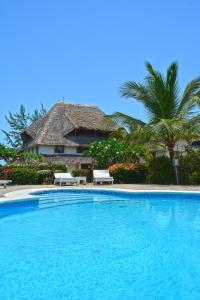 a swimming pool in front of a resort at Alawi Home in Watamu