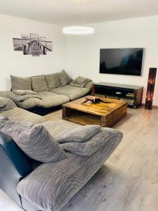 a living room with a couch and a coffee table at Apartmánové domy Kaja, Niko, Simi in Veľký Meder +45 photos