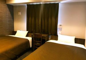Postel nebo postele na pokoji v ubytování Hotel Trend Omiya