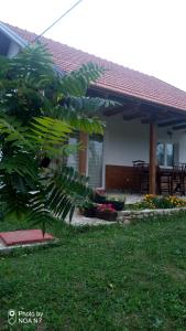 a house with a patio with a bunch of flowers at Nektar Park Villa Sara in Bihać