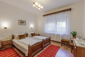 a bedroom with a large bed and a window at Zseri Vadászház in Fehérvárcsurgó +222 photos