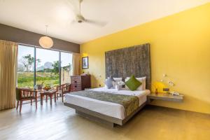 A bed or beds in a room at Sigiriya King's Resort