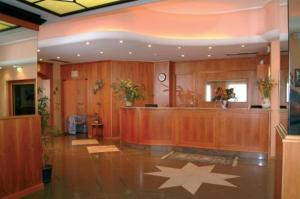 a lobby with a reception desk and a star on the floor at Lo Scoiattolo in Massino Visconti