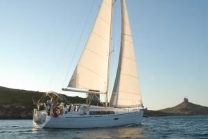 a sailboat with white sails on the water at Boat & Sailing Torregrande Sinis Yachting in Oristano +19 photos