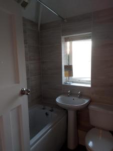 a bathroom with a sink and a tub and a toilet at Fifty-five in Bristol