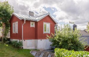 a red house with a white at Vaxholm Seaview Cottage in Vaxholm