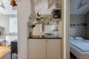 una cocina con encimera y una cama en una habitación en Vaxholm Seaview Cottage, en Vaxholm