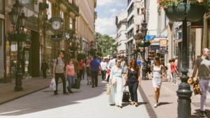 a group of people walking down a busy city street at Apartman 4 YOU 2. in Budapest