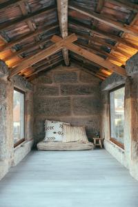 ポイオにあるCasa da Oliveiraの木製天井の石造りの部屋のベッド1台