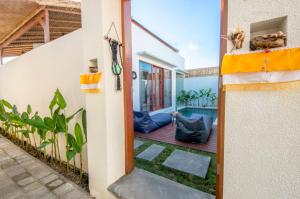 an open door of a house with a yard at Kiki Village Private Villas in Canggu