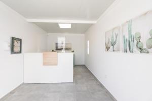 a room with white walls and paintings on the walls at Apartamentos Aloe in Puerto del Carmen