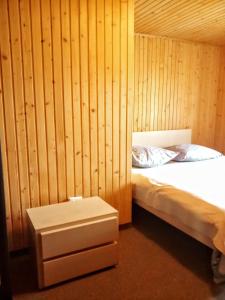 a bedroom with a bed and a wooden wall at Гостьовий дім "У Ані" in Yablunytsya