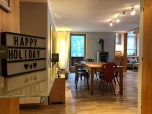 a living room with a table and chairs at Haus Albona in Klösterle