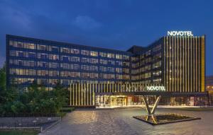 a hotel with a sign on the front of it at Novotel Nanjing East Suning in Nanjing