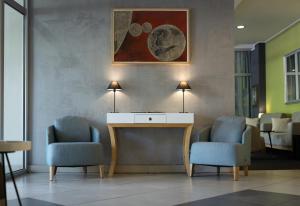 a waiting room with two chairs and a table at BLEECKER Hotels in Belgrade