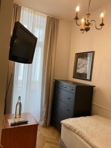 
a bedroom with a tv and a bed at Pension Nossek in Vienna
