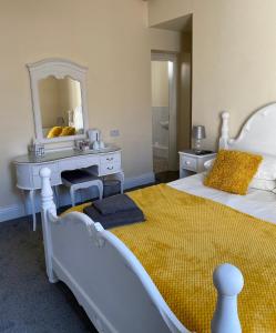 a bedroom with a bed and a dresser at Hawthorn House in Blackpool