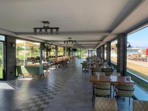 a restaurant with tables and chairs and windows at Özkum Tesisleri in Sapanca +57 photos