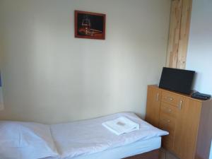 1 dormitorio con cama y vestidor con TV en Zajazd Joniec Małgorzata en Dobra