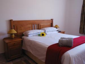 ein Schlafzimmer mit einem Bett mit Sonnenblume darauf in der Unterkunft El Rancho Grande in Bela-Bela