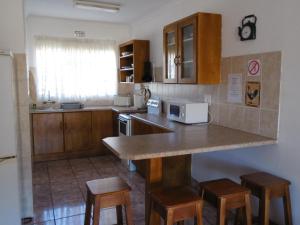 a kitchen with a counter and some wooden cabinets at El Rancho Grande in Warmbaths