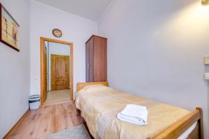 ein kleines Schlafzimmer mit einem Bett und einem Flur in der Unterkunft Park Lane Inn in Sankt Petersburg